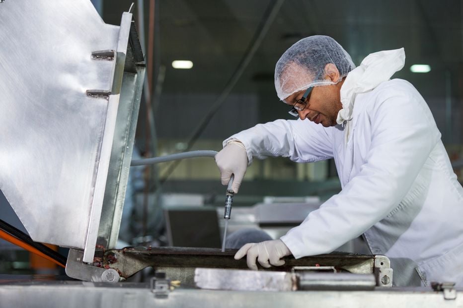 Worker cleaning a machine