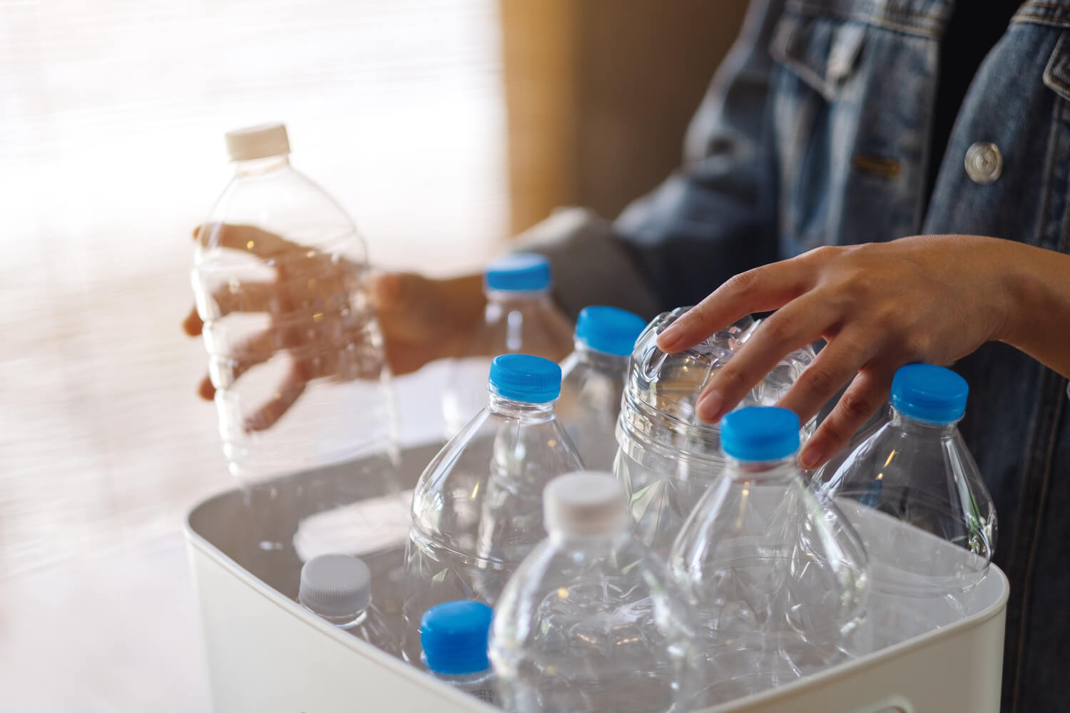 Person recycling plastic bottles