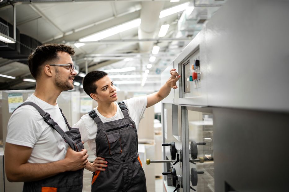 Two operators at a machine