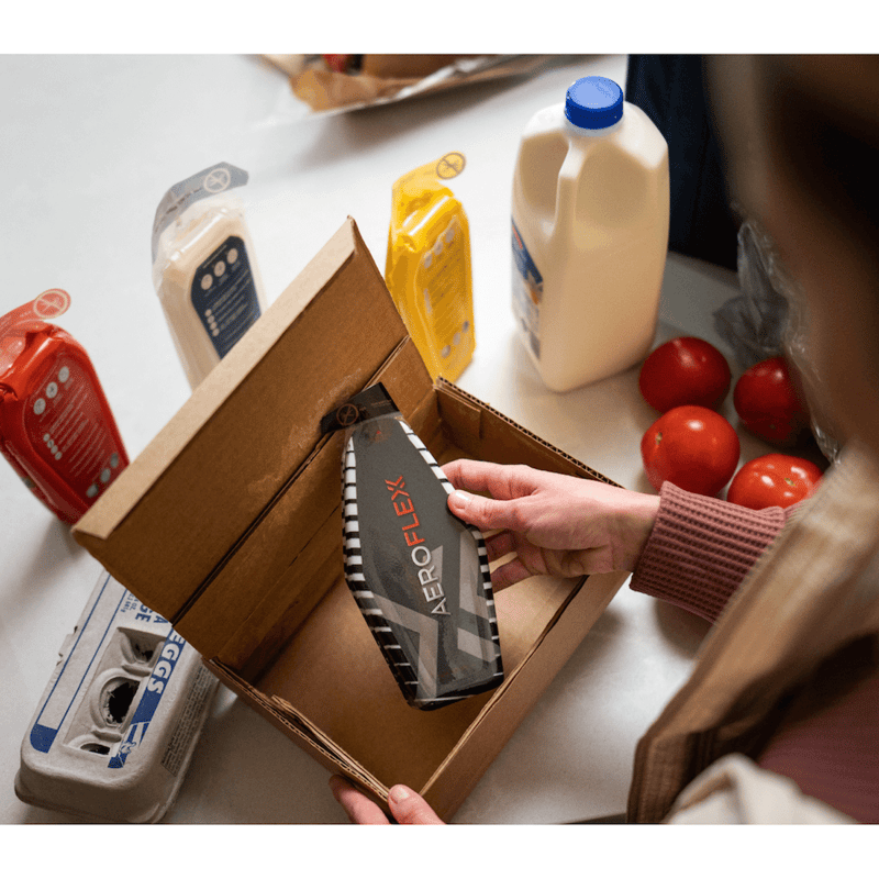 Woman taking Aeroflexx package out of a cardboard box